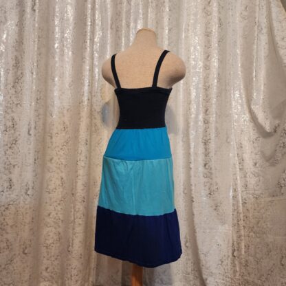 Elastic fit top with strap over the shoulders.  3 shades of blue color skirt for a simple yet cute look.  Get this dress for cover all party dress.