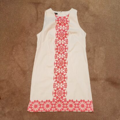 Lay flat soft red geometric pattern dress with a shift style fit. A perfect semi formal dress